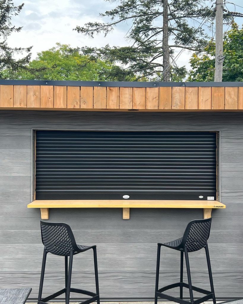 A rollshutter installed on a passthrough window with a locking mechanism to protect against possible intrusions.