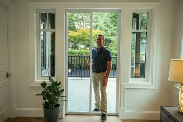 guy walking through a wizard retractable screen door
