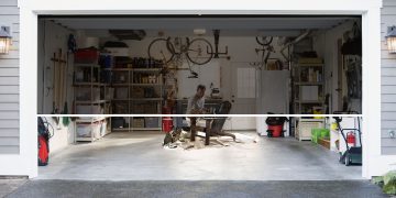 A picture of a large retractable screen door for a garage door opening.
